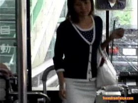 A young Asian girl enters a public bus and sits down from http://alljapanese.net